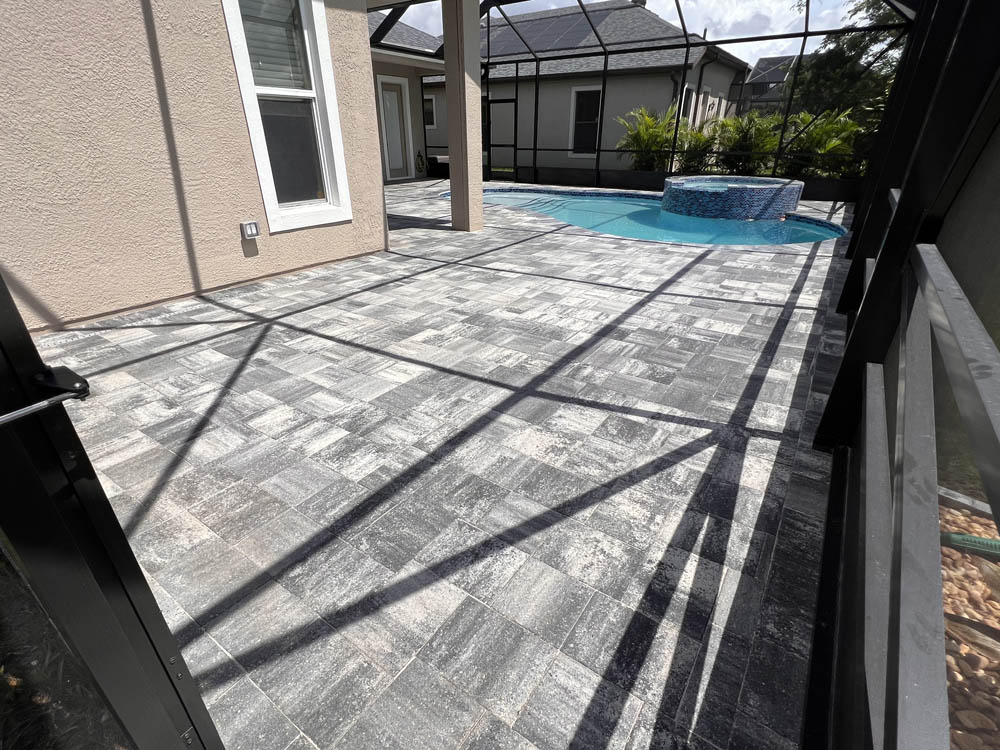 Paver pool deck that was pressure washed, sealed, and resanded by Stellar Paver Sealing in Viera